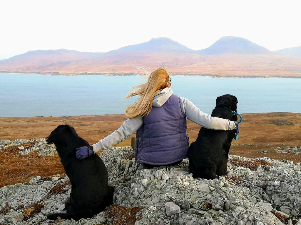 Girl sat with two dogs