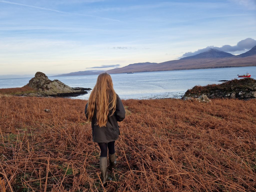 girl with long hair looking out to sea