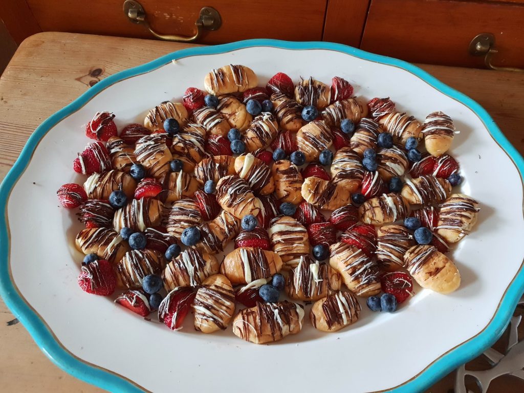 A serving plate filled with profiteroles