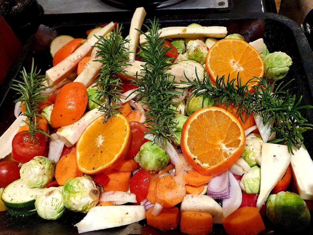 Chopped fruit, vegetables and herbs in a roasting tin