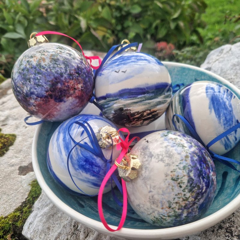 A bowl filled with large ceramic baubles