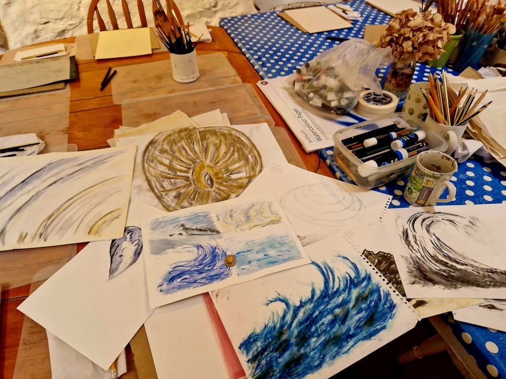 Pastel sketches of waves, and shells on a table